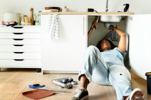 woman taking care of plumbing