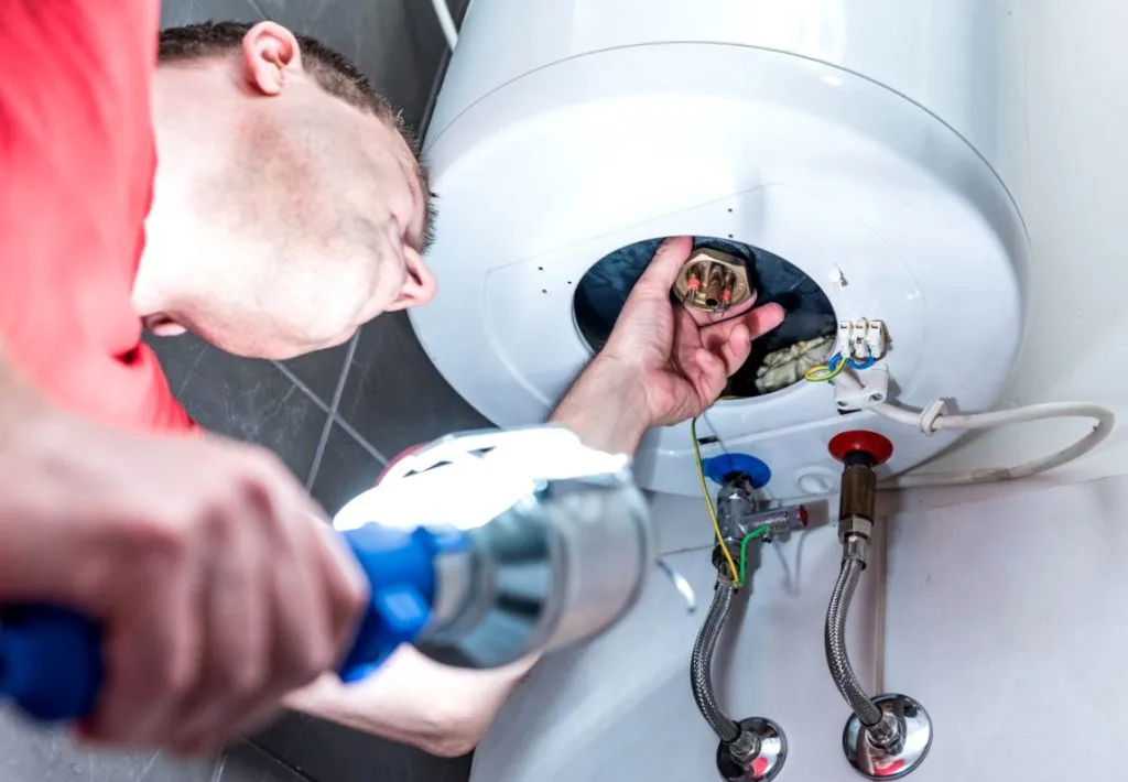 plumber checking a hot water system