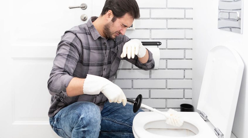 someone noticing a foul smell in a business or a plumber checking pipes