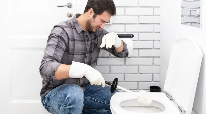 someone noticing a foul smell in a business or a plumber checking pipes