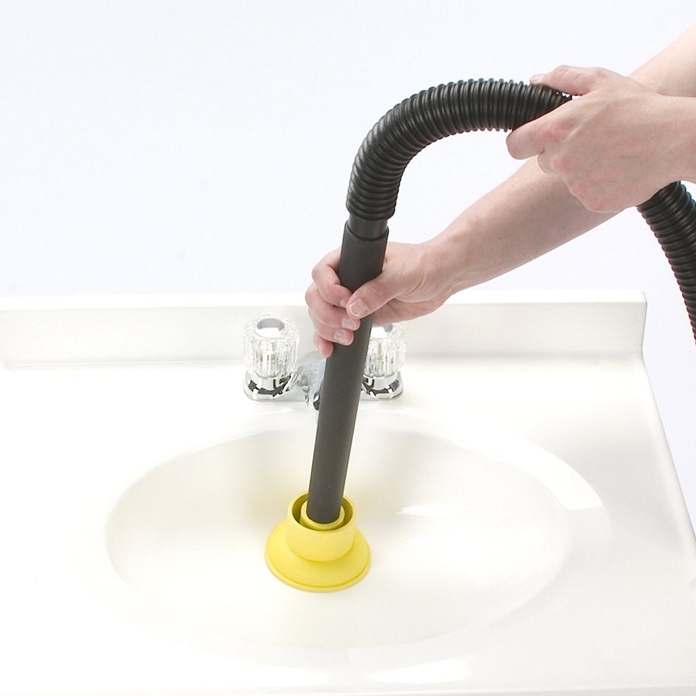 wet dry shop vacuum with its hose over a drain